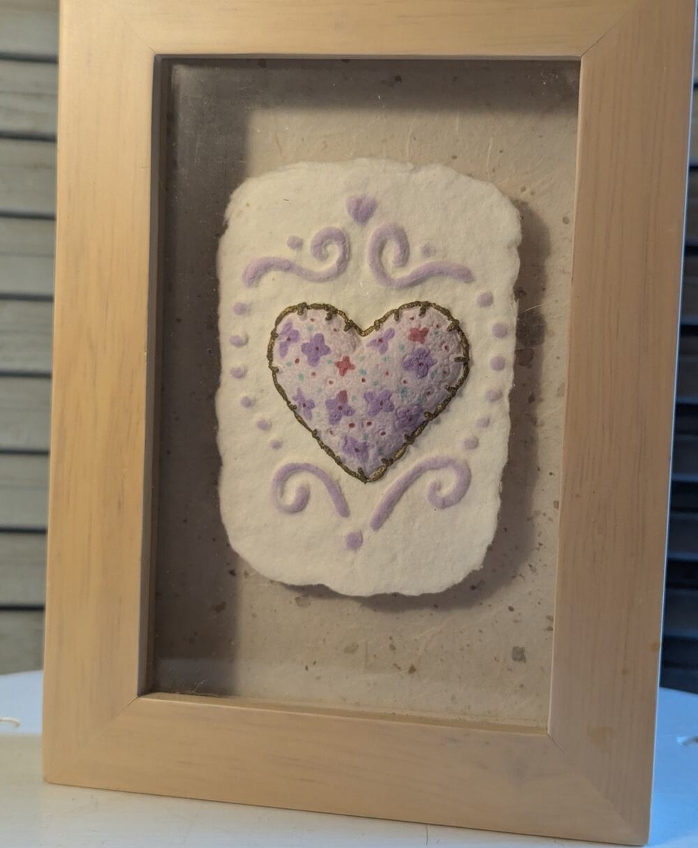 Framed, handmade cast paper art with floral heart design